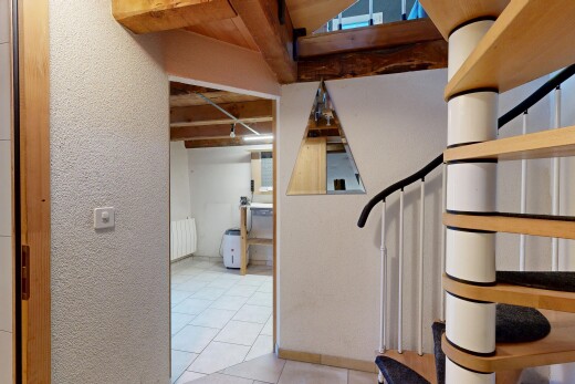 stairs featuring tile patterned floors and radiator heating unit