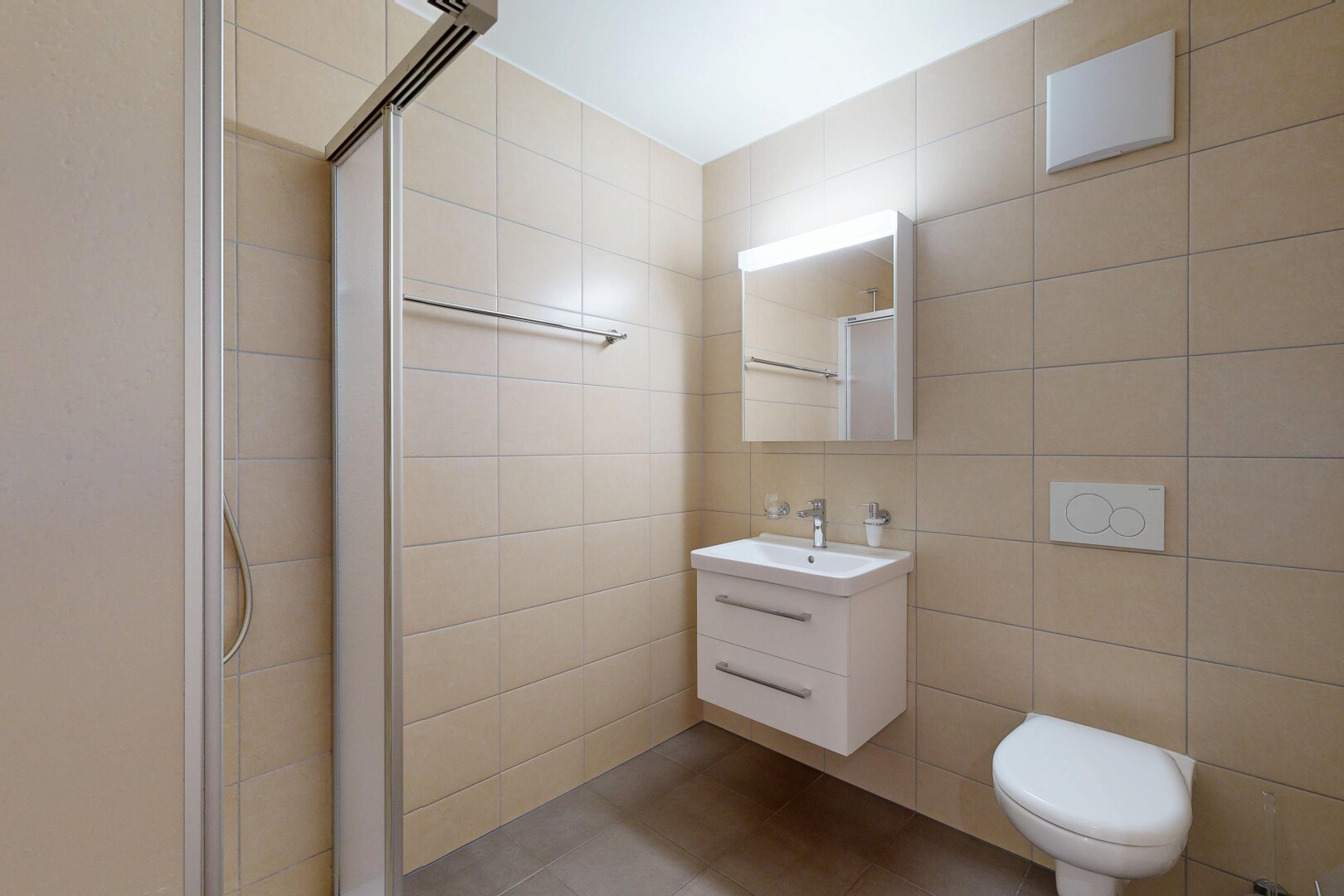 full bathroom with a stall shower, tile walls, vanity, and light tile patterned flooring