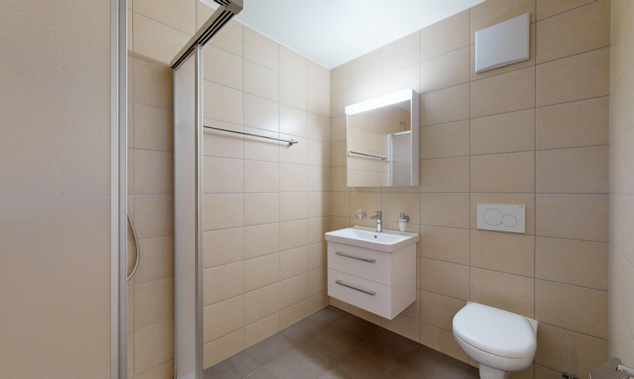 full bathroom with a stall shower, tile walls, vanity, and light tile patterned flooring
