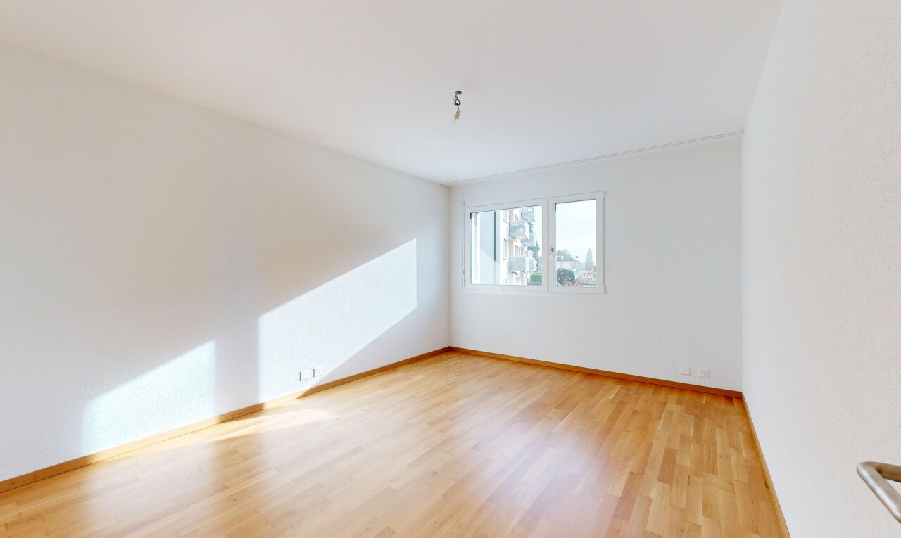 unfurnished room featuring light wood finished floors and baseboards