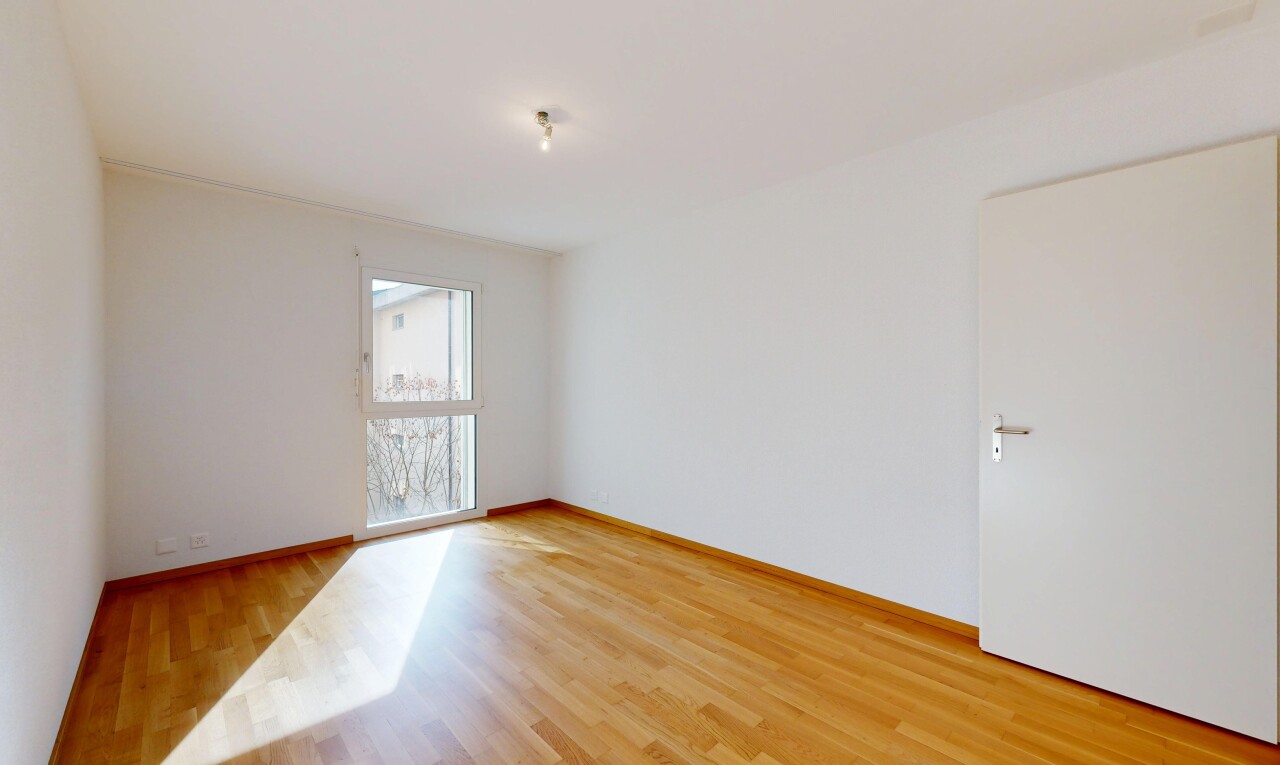 spare room featuring light wood-style floors and baseboards