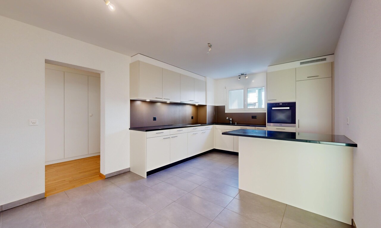 kitchen featuring light tile patterned floors, dark countertops, black oven, and modern cabinets