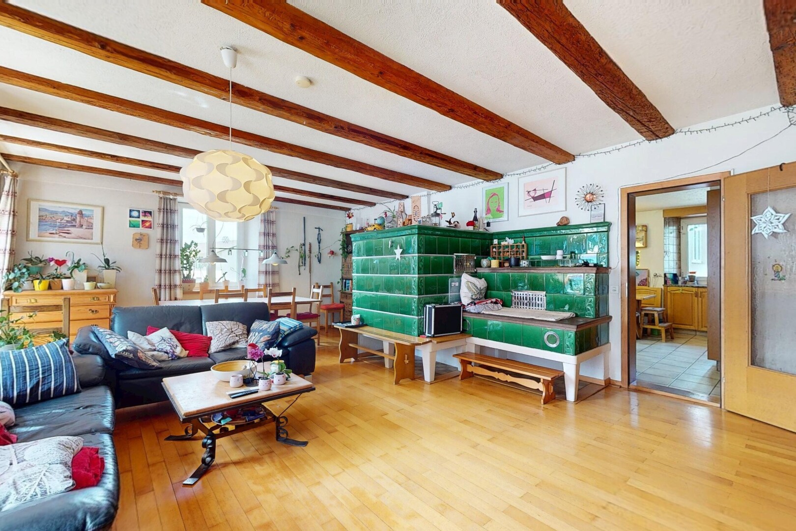 living room featuring beam ceiling, wood finished floors, and plenty of natural light