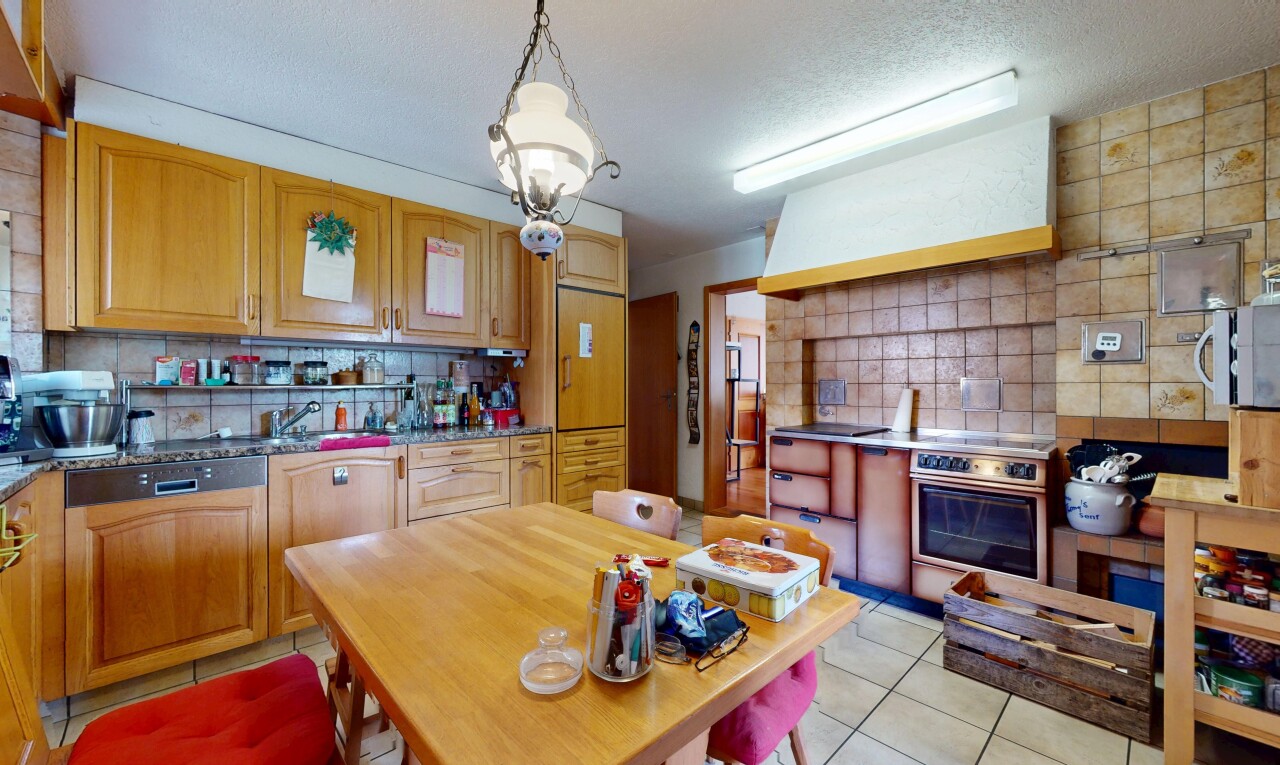 kitchen with backsplash, light tile patterned flooring, extractor fan, oven, and hanging light fixtures