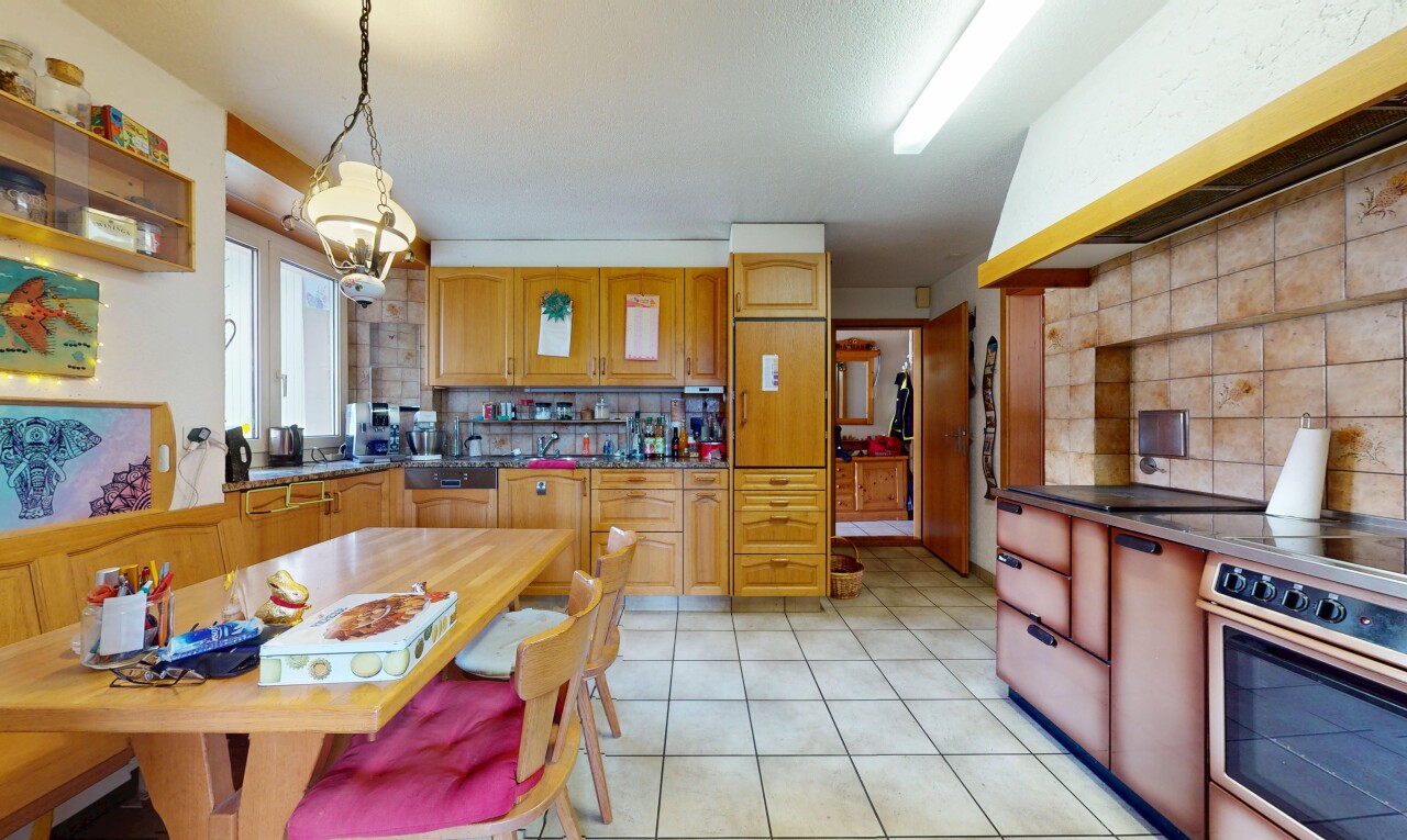 kitchen with backsplash, decorative light fixtures, light tile patterned flooring, and range hood