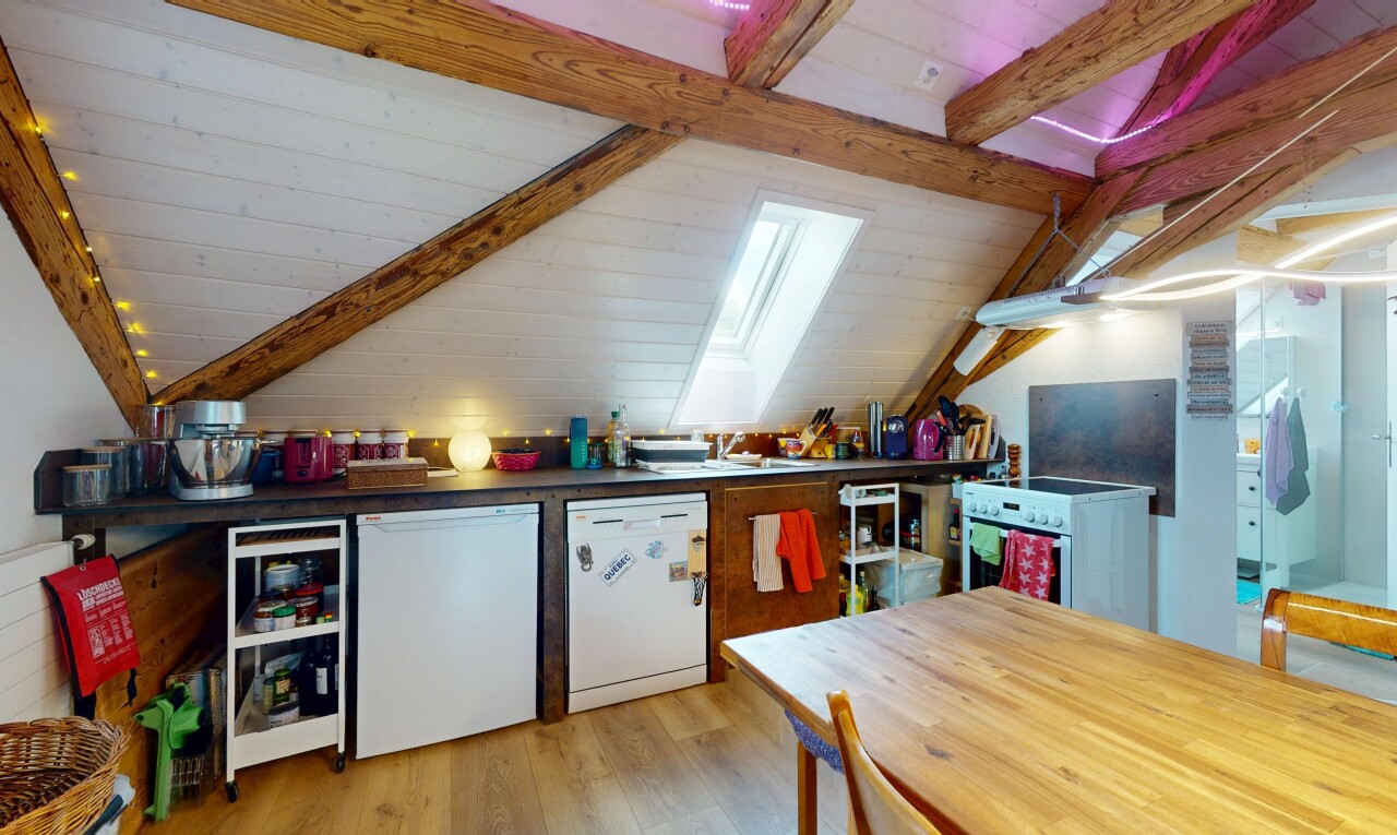 kitchen featuring white appliances, light wood-type flooring, and a skylight