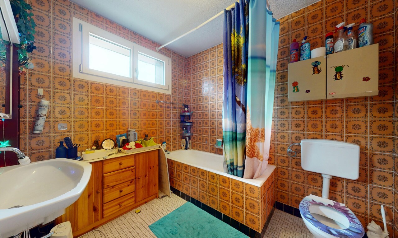 full bathroom with tiled shower / bath combo, light tile patterned floors, and tile walls