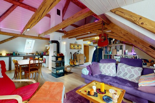 salon / salle à manger avec poêle à bois, sol en finition bois, wood finish floor, inside property, et plafond à poutres