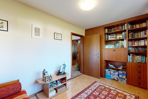 living area featuring light wood-style flooring and built in features