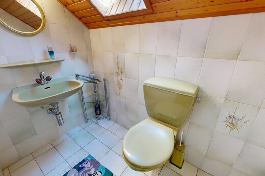 bathroom with tile walls, light tile patterned flooring, and a vaulted wooden ceiling