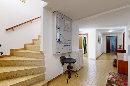 stairway with brick patterned floors and baseboards