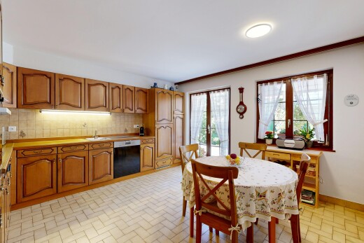 kitchen with wood finish cabinetry, access to exterior, light countertops, and dishwasher