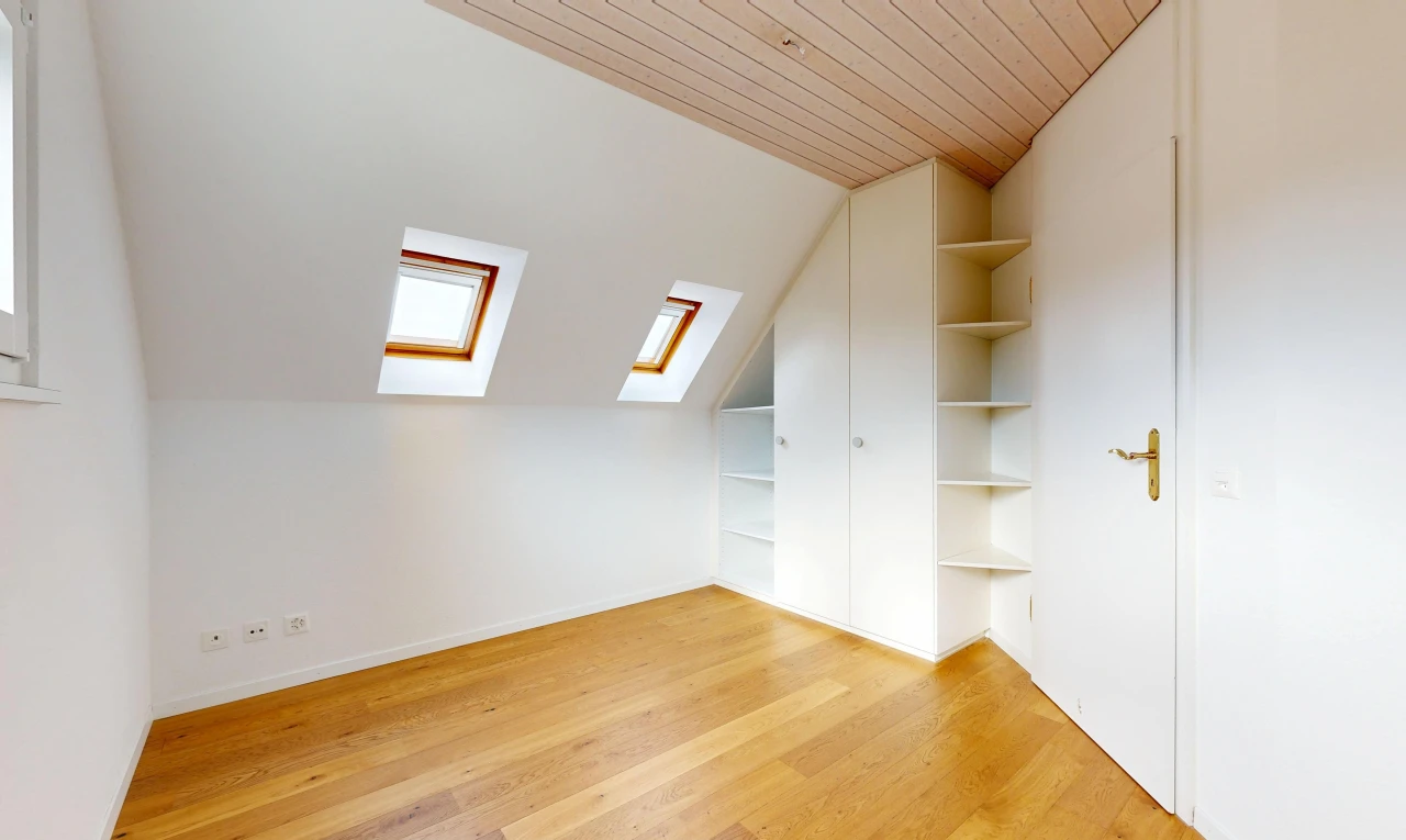 pièce vide avec puits de lumière, vaulted ceiling, plafond voûté, étagères intégrées, et pièce supplémentaire