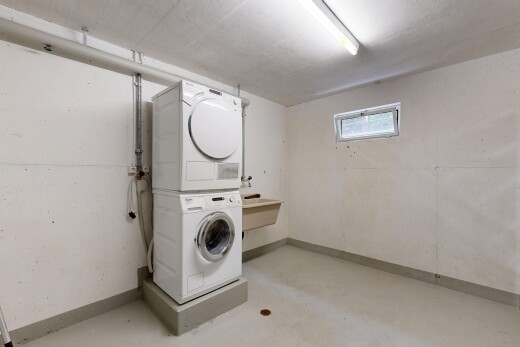laundry area with stacked washer and clothes dryer
