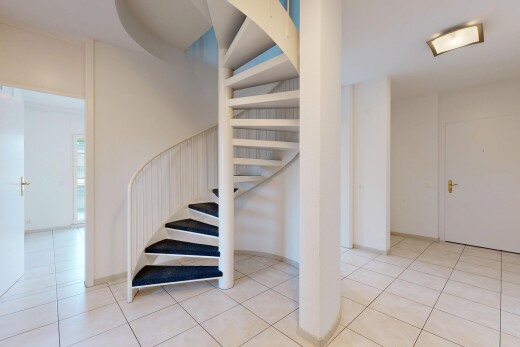stairway featuring light tile patterned floors