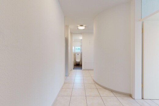 hallway featuring light tile patterned flooring