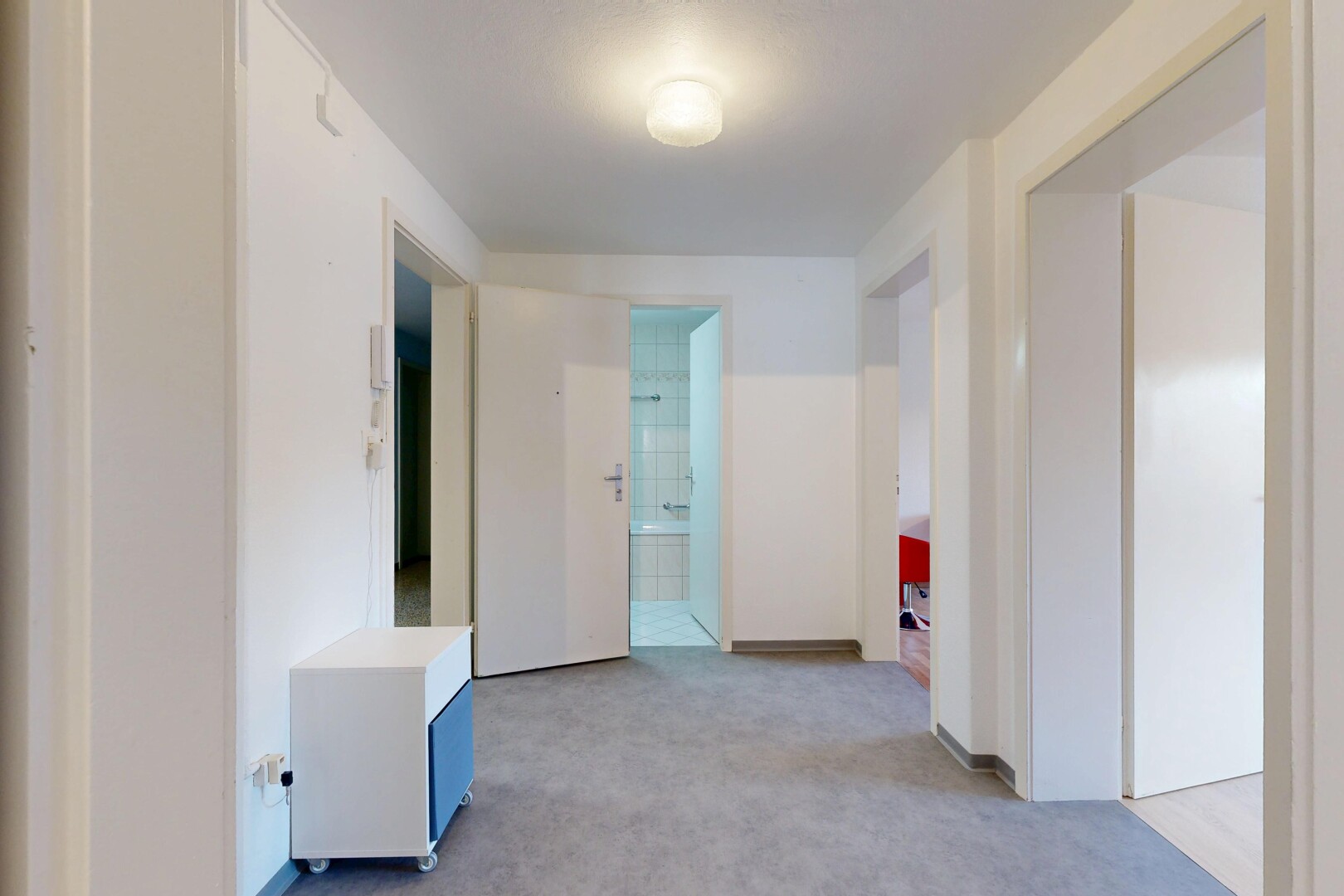 hall with light colored carpet