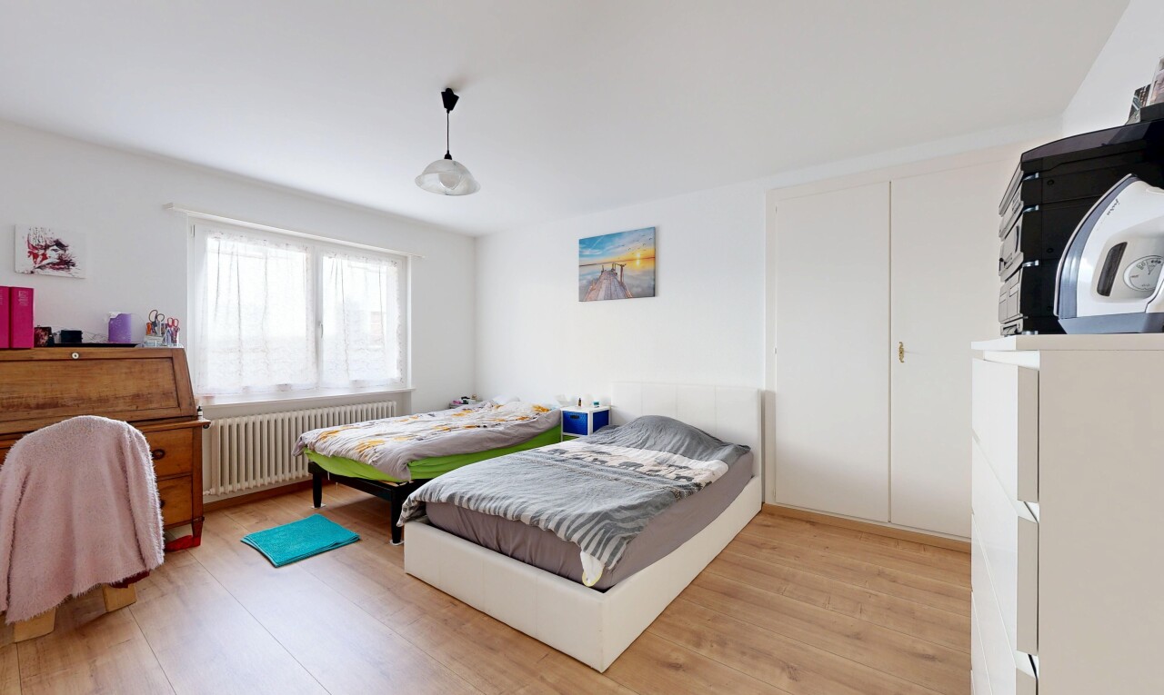 room featuring radiator heating unit and light wood finished floors