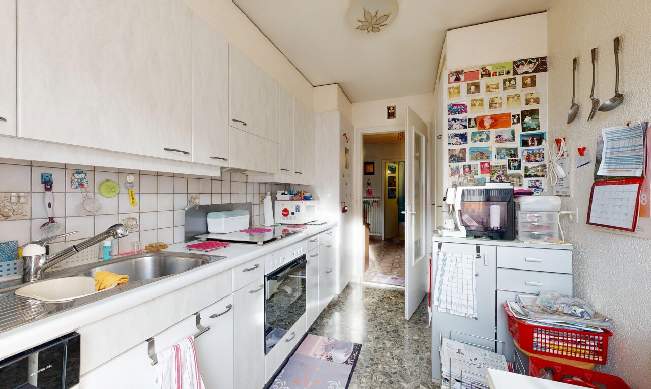 kitchen featuring stainless steel oven, light countertops, white cabinetry, backsplash, and black electric stovetop