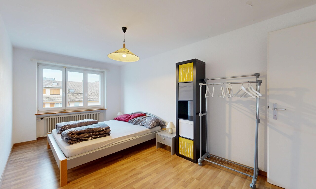 room with radiator and light wood-type flooring