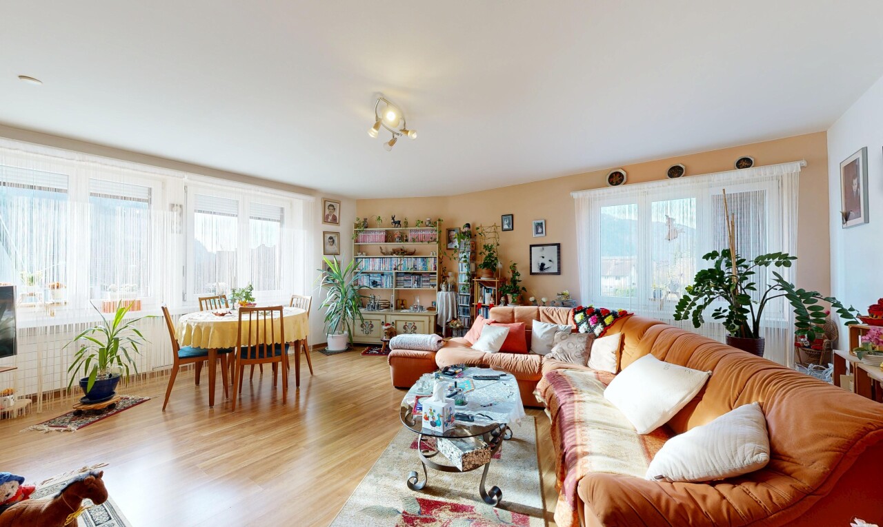 living / dining area with plenty of natural light and wood finished floors