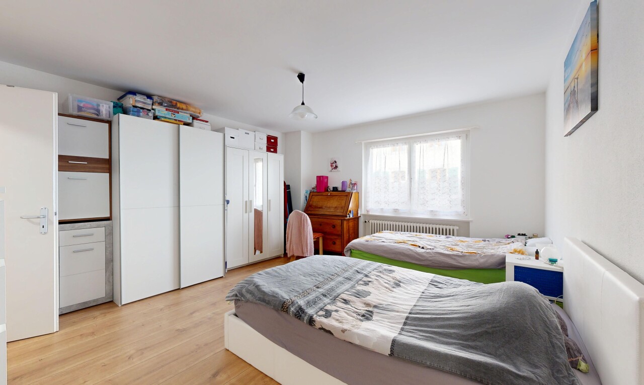 room / bedroom with light wood finished floors and radiator