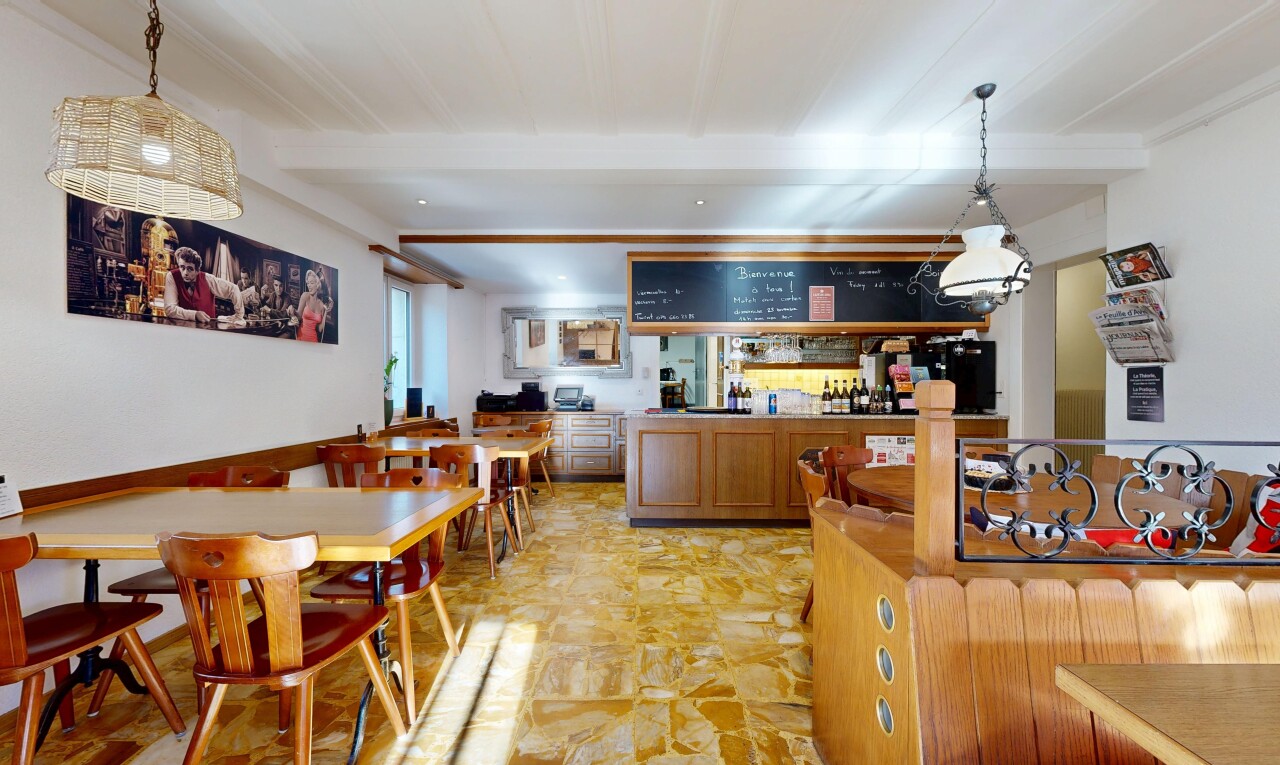 dining space featuring a community bar and beamed ceiling