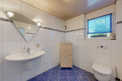 bathroom with tile walls and dark tile patterned flooring