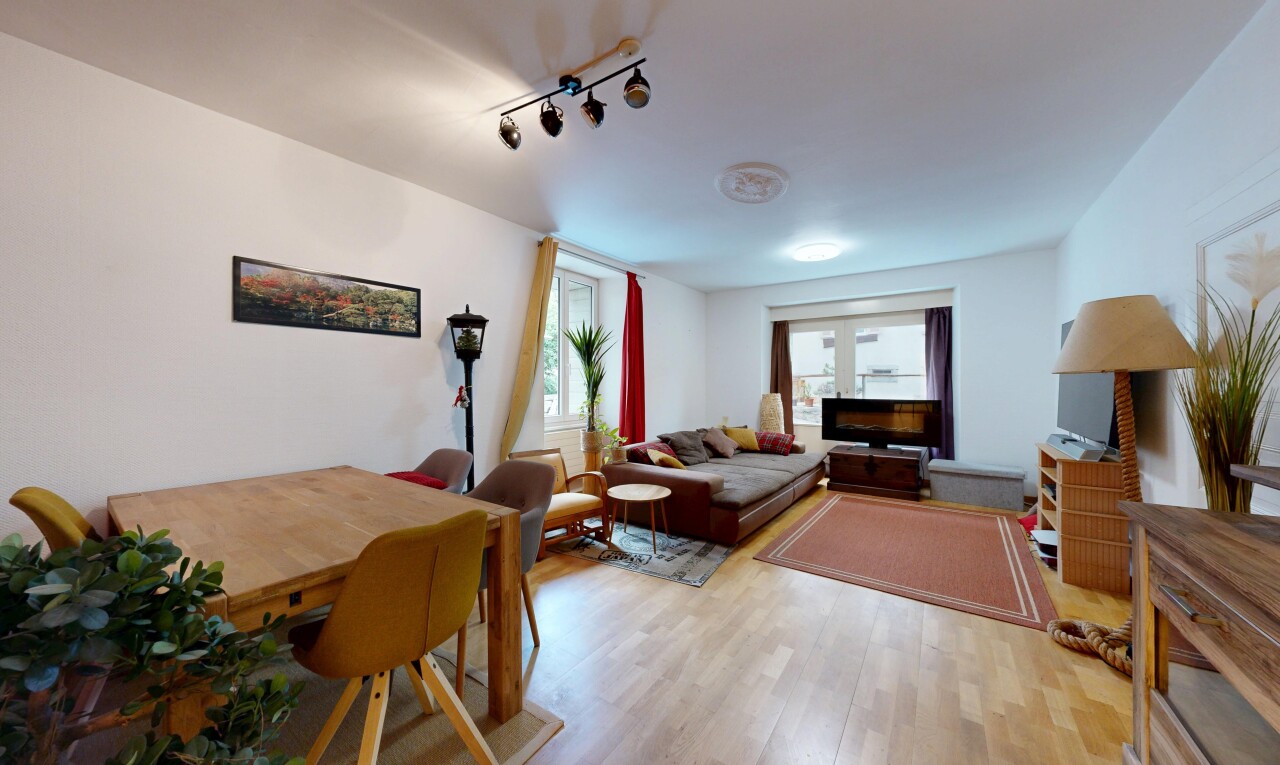 salon / salle à manger avec drywall, cloison sèche, wood finish floor, sol en finition bois, et éclairage sur rail