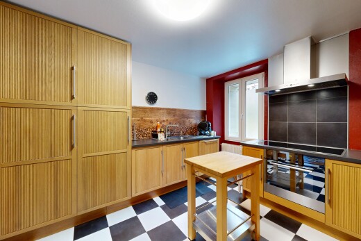 kitchen featuring dark flooring, dark countertops, stainless steel oven, and backsplash