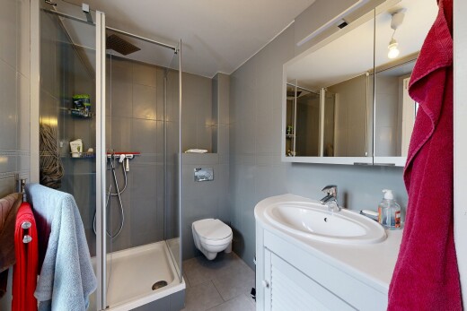 bathroom featuring a shower stall, vanity, and light tile patterned flooring