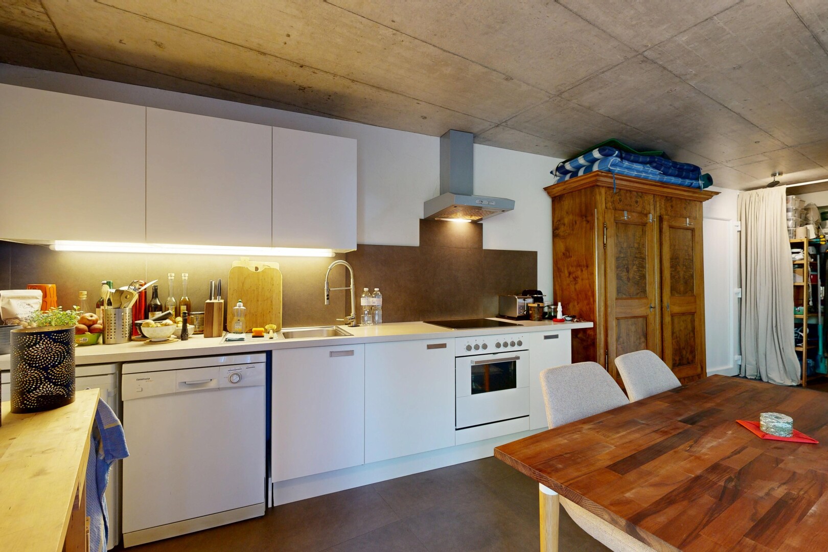 kitchen with white appliances, white cabinets, concrete floors, decorative backsplash, and butcher block counters