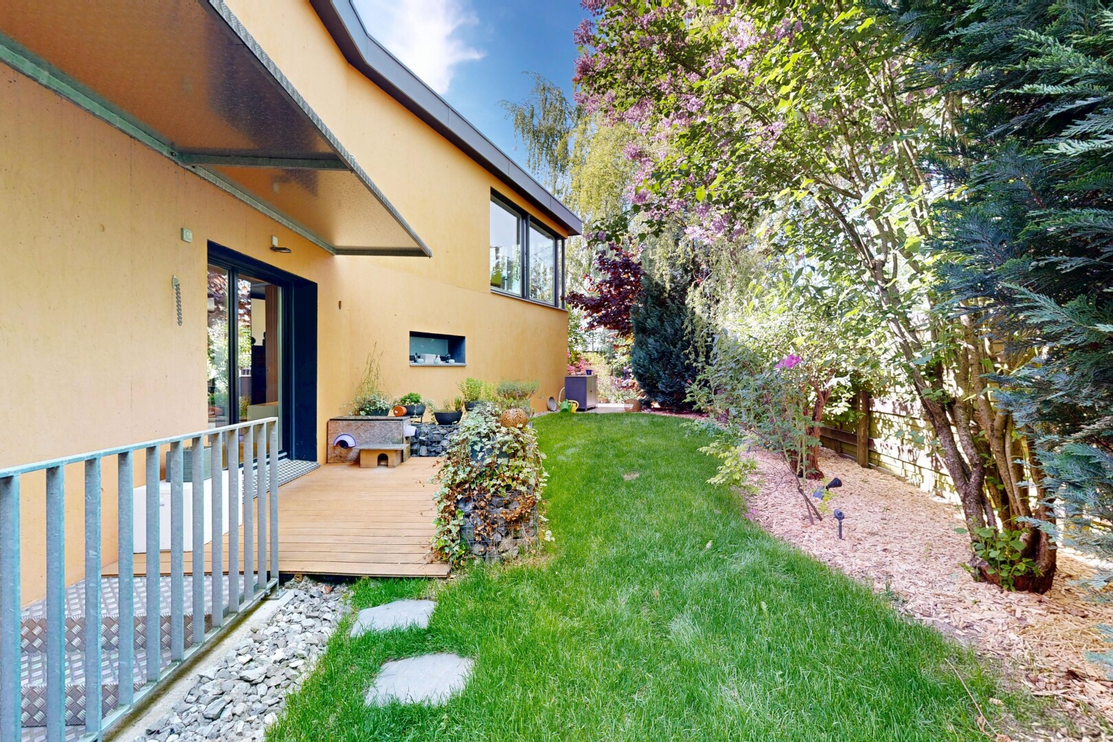 garden featuring a wooden deck and a yard