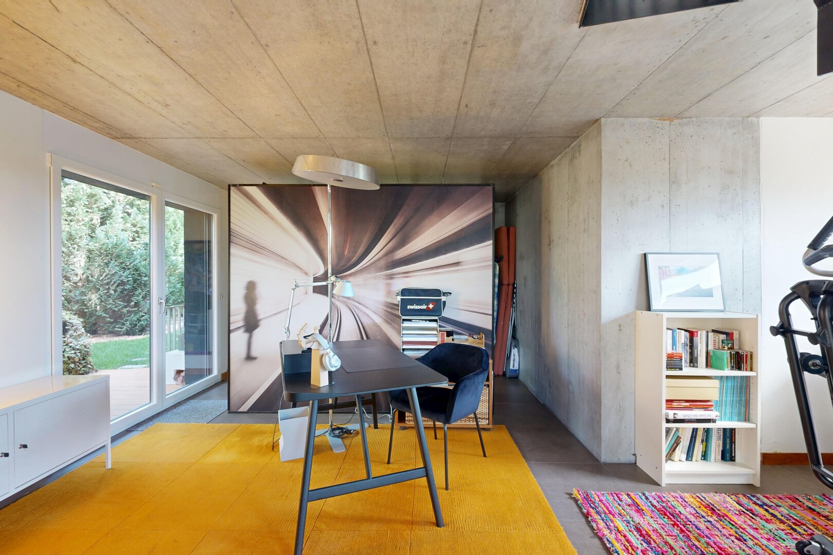 dining room featuring concrete flooring and a desk