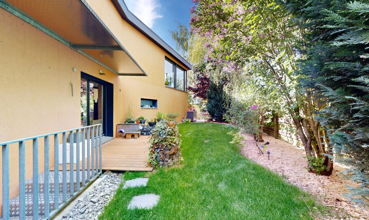 garden featuring a wooden deck and a yard
