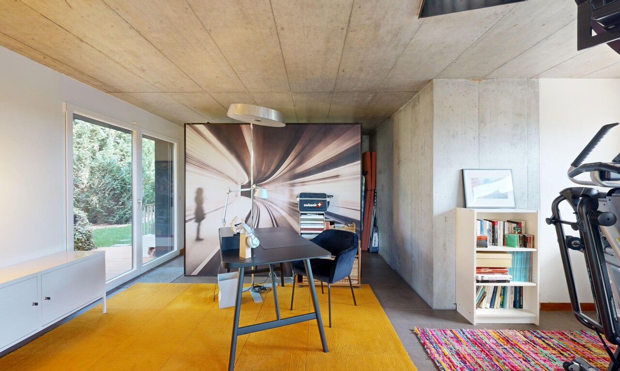 dining room featuring concrete flooring and a desk