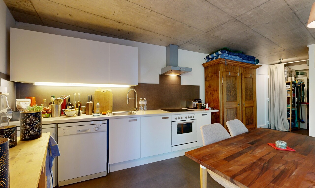 kitchen with white appliances, white cabinets, concrete floors, decorative backsplash, and butcher block counters