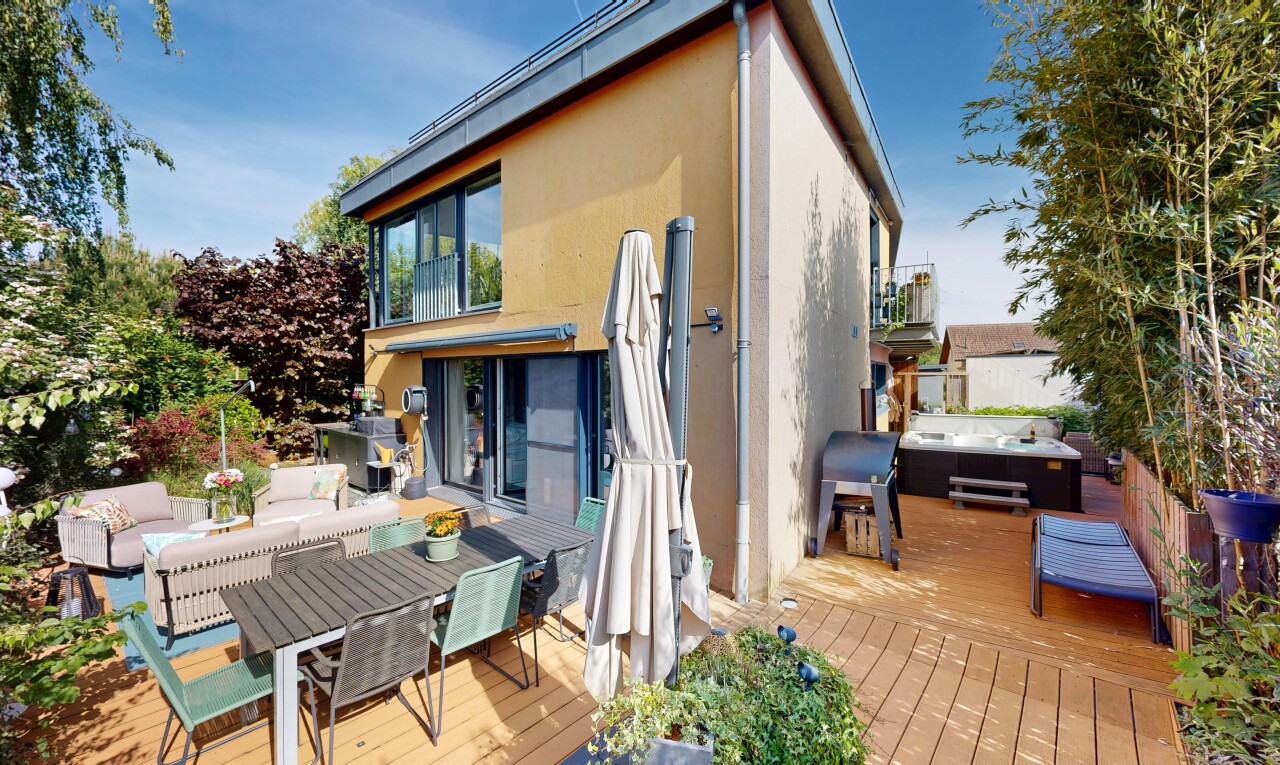 view of wooden deck featuring outdoor dining area, a balcony, and a hot tub