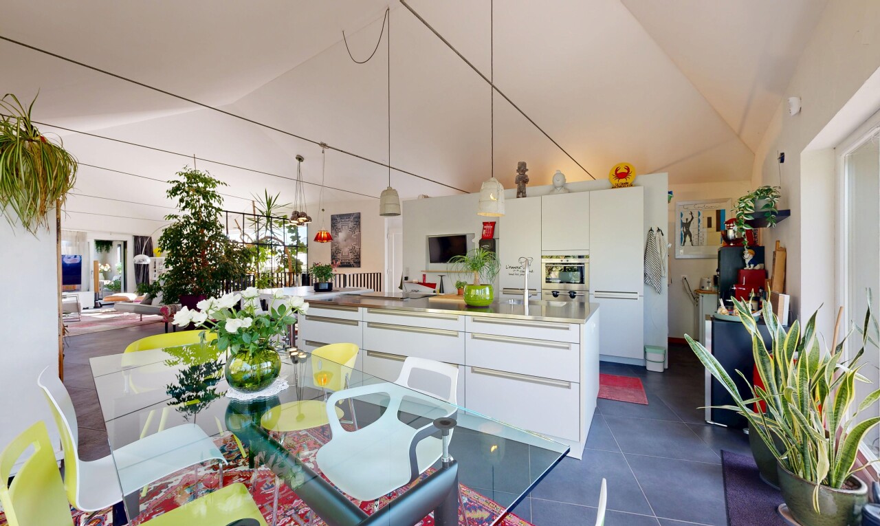 kitchen with white cabinets, lofted ceiling, modern cabinets, oven, and light countertops