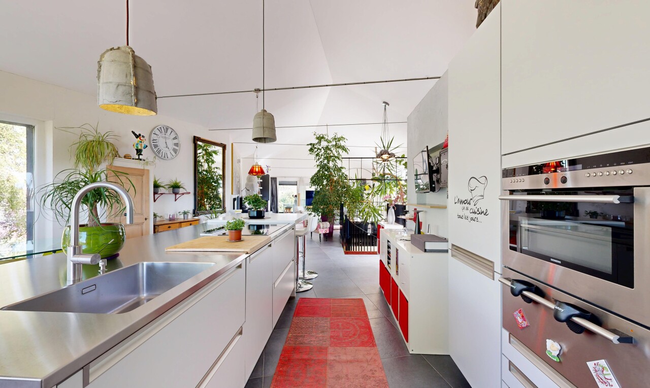 kitchen with oven, white cabinetry, light countertops, a warming drawer, and hanging light fixtures