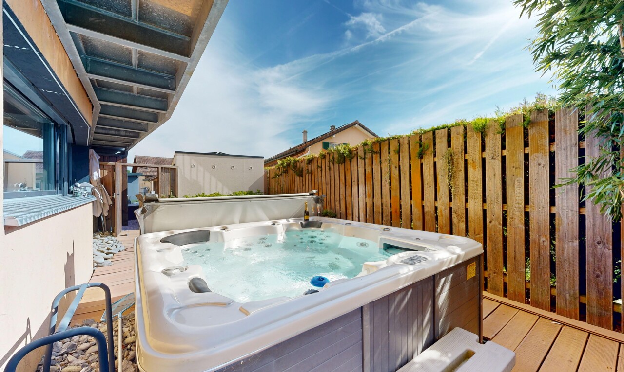 view of swimming pool with a deck and a hot tub