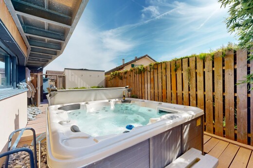 view of swimming pool with a deck and a hot tub