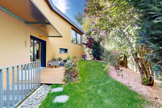 garden featuring a wooden deck and a yard