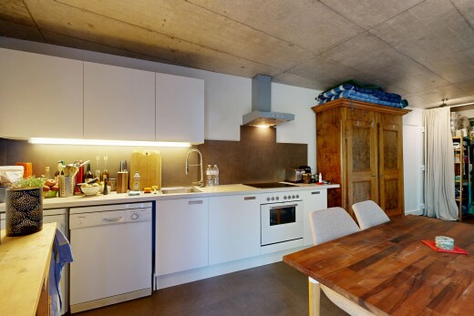 kitchen with white appliances, white cabinets, concrete floors, decorative backsplash, and butcher block counters