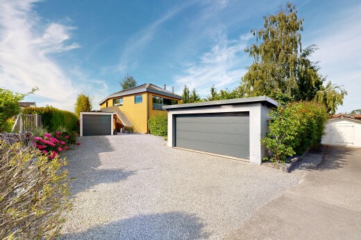 view of home with an outdoor structure, a garage, and stucco siding