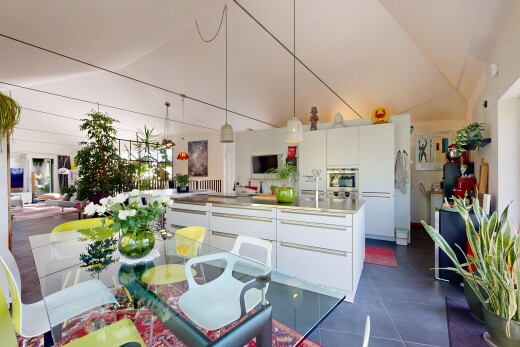 kitchen with white cabinets, lofted ceiling, modern cabinets, oven, and light countertops