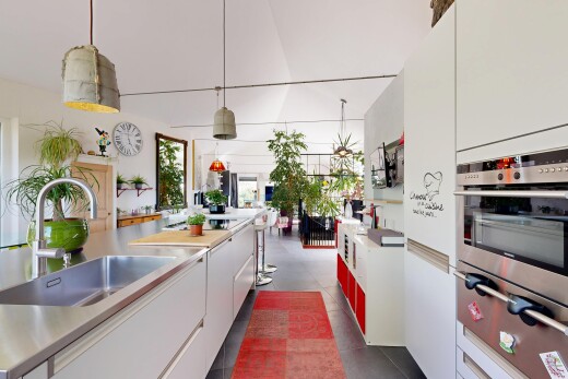kitchen with oven, white cabinetry, light countertops, a warming drawer, and hanging light fixtures