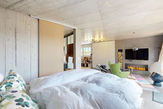 room / bedroom featuring a warm lit fireplace