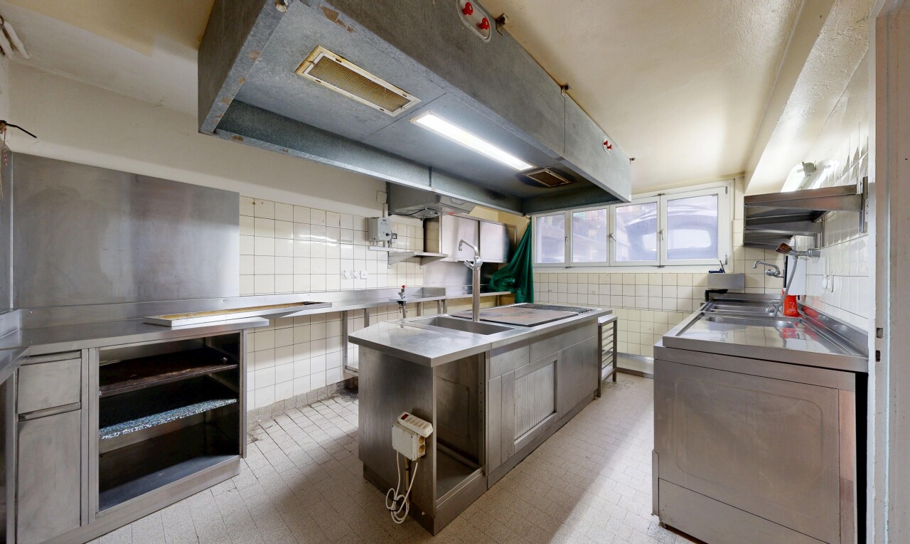cuisine avec plans de travail en acier inoxydable, lave-linge et sèche-linge, inside property, sol en vinyle, et vinyl floor
