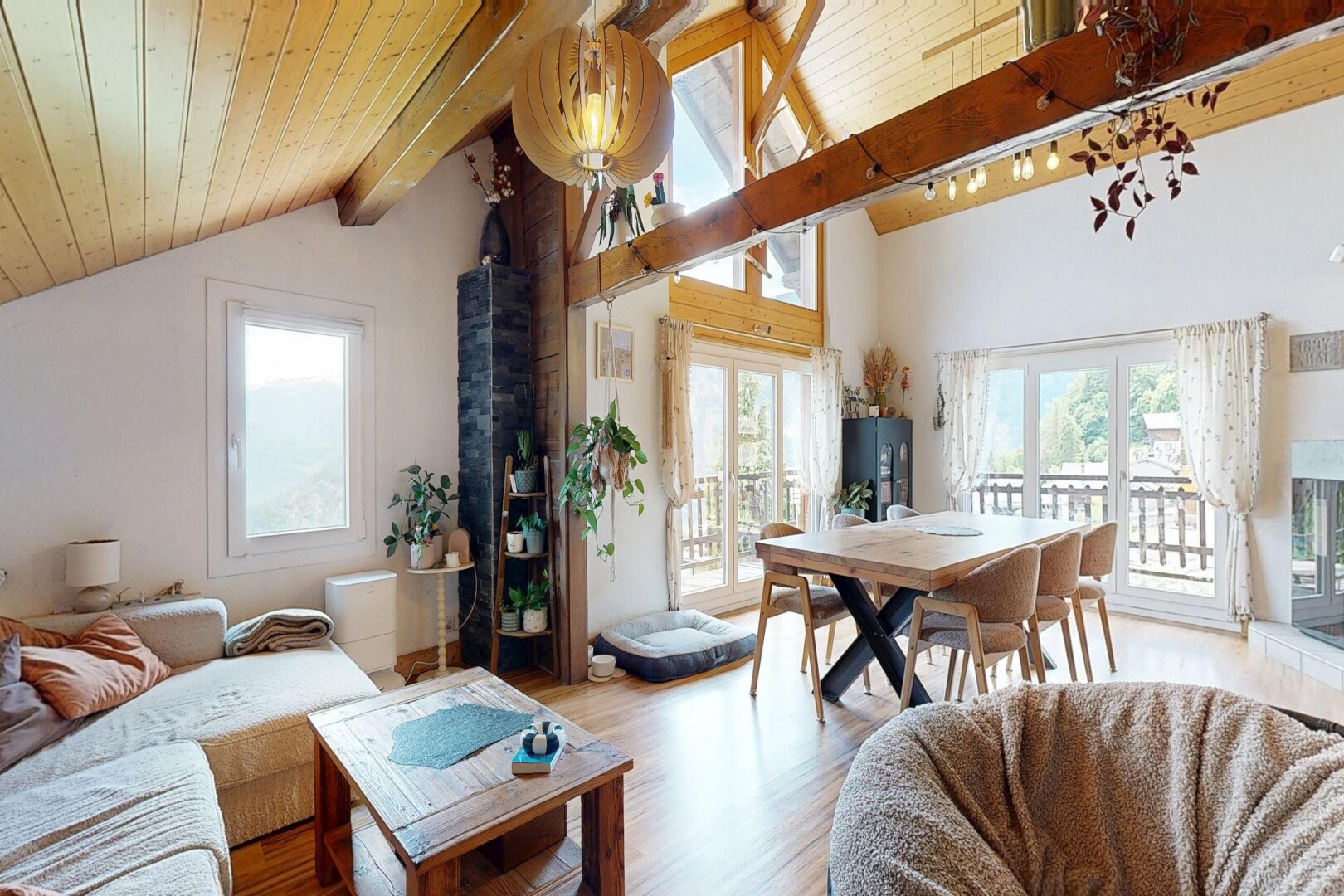 living area featuring light wood-style flooring and a high wood beamed ceiling